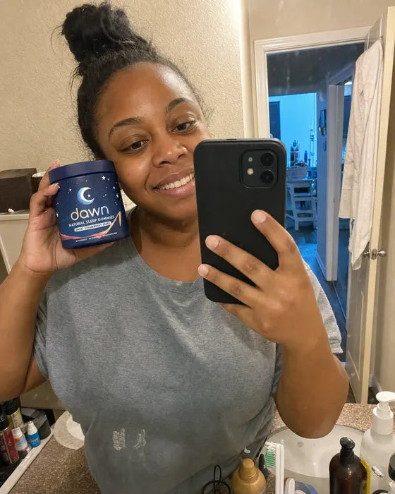 Customer holding Dawn jar in bathroom mirror